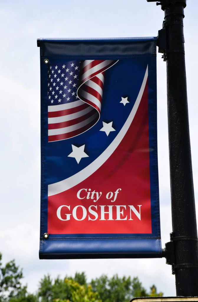 City of Goshen banner with American flag and stars on a street pole