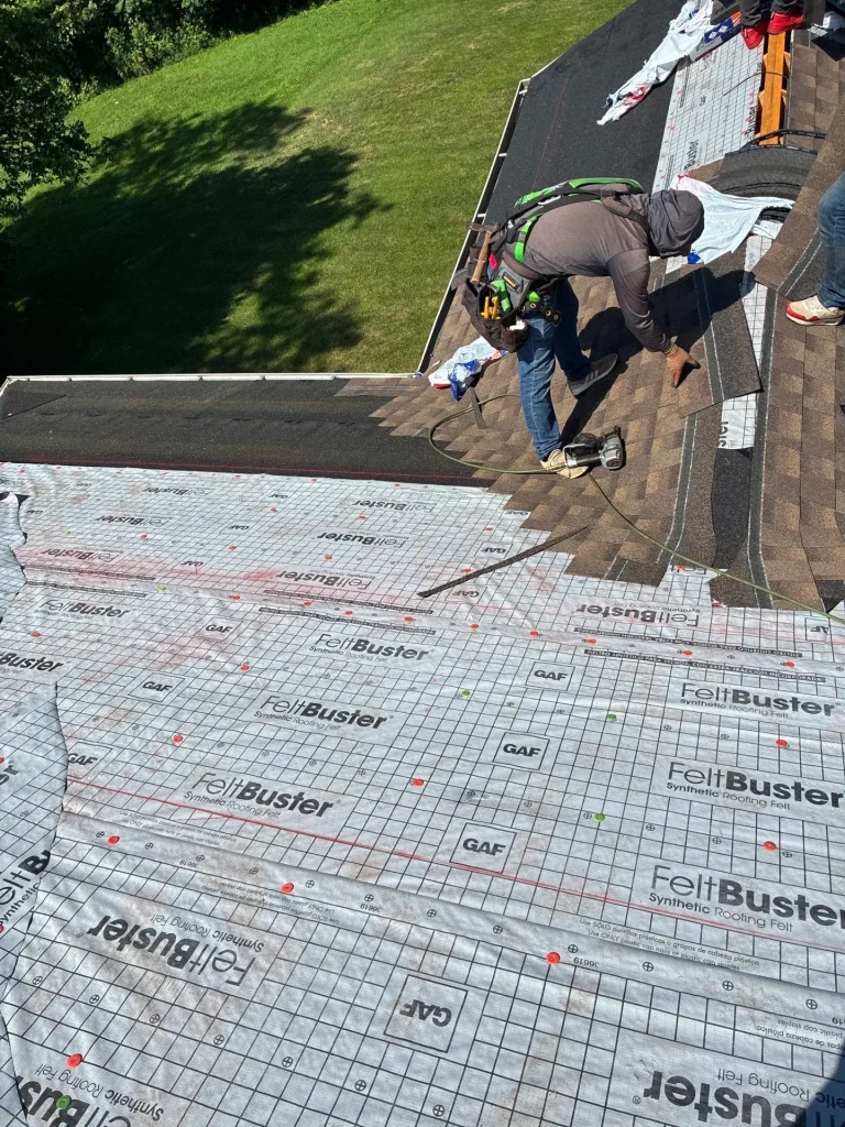 AIC Roofing & Construction crew member repairing roof with GAF FeltBuster underlayment on a Richmond, KY home