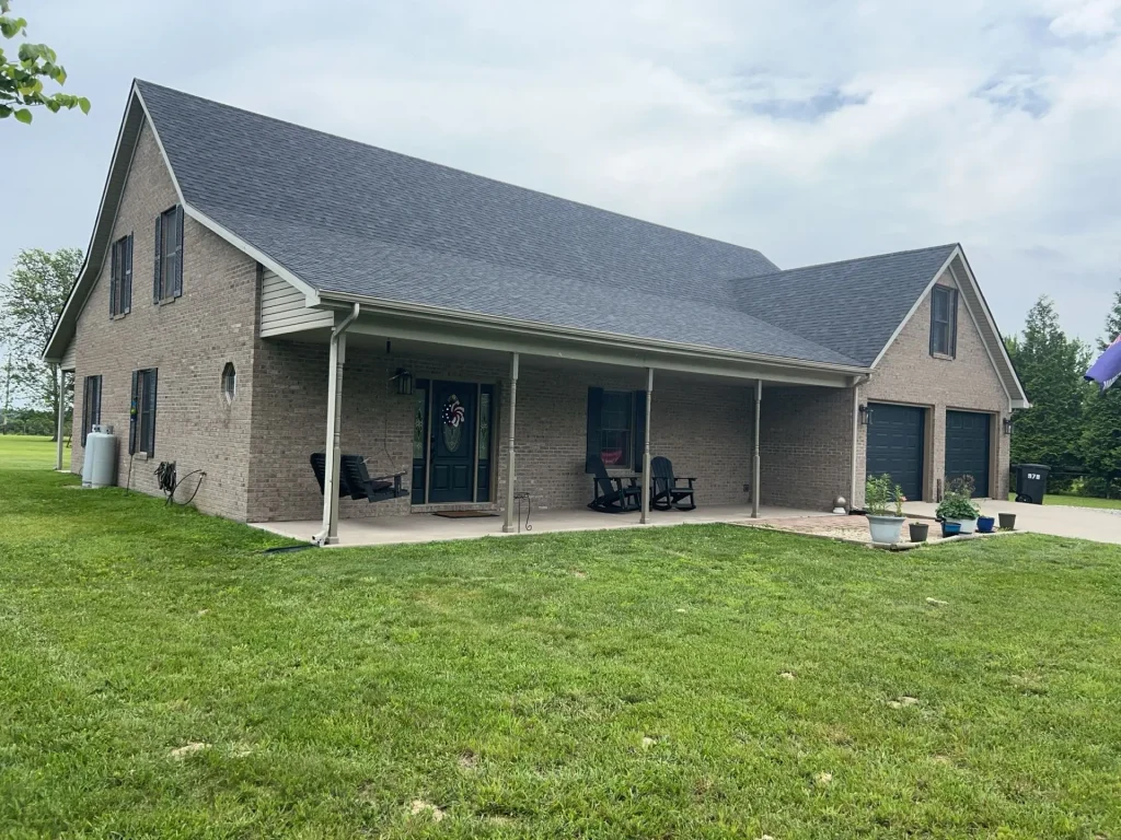 New asphalt shingle roof installed on a large brick home in Richmond, KY by AIC Roofing & Construction