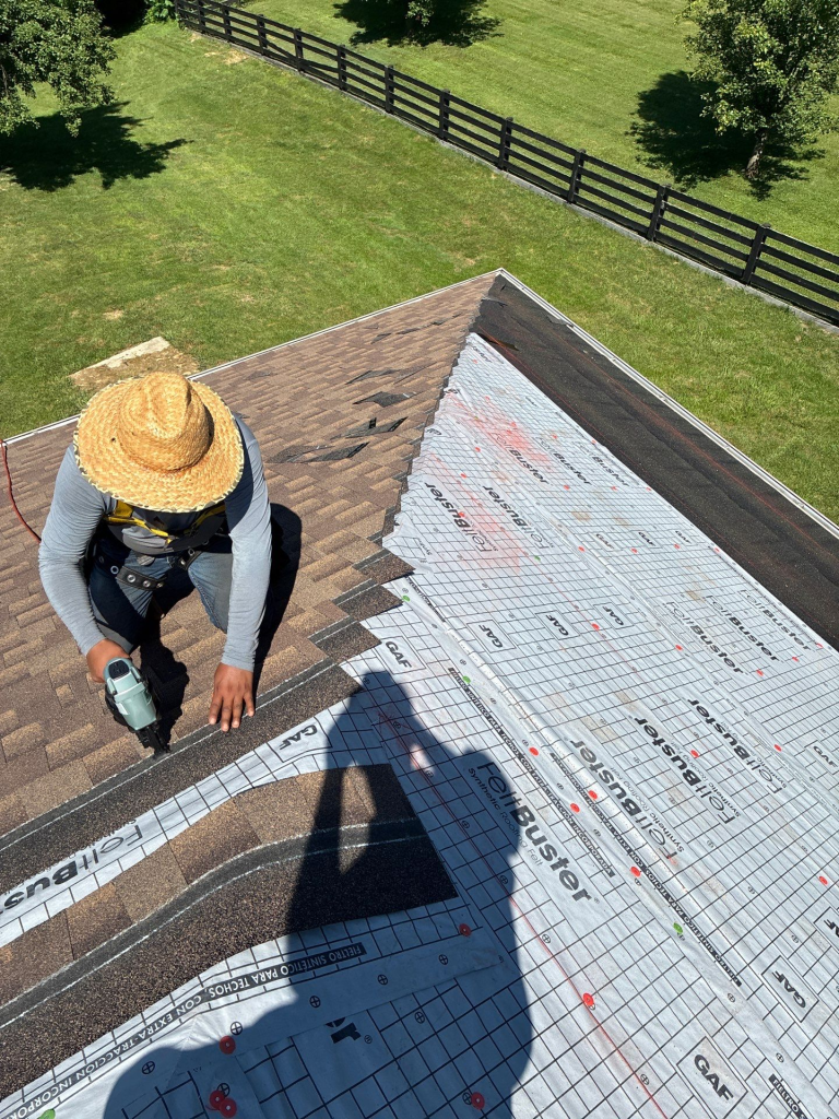 AIC Roofing crew member installing shingles during a roof repair in Richmond, KY using GAF FeltBuster underlayment