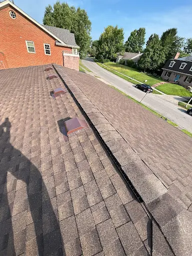 Rooftop view of a Richmond, KY home with brown asphalt shingles and installed attic vents