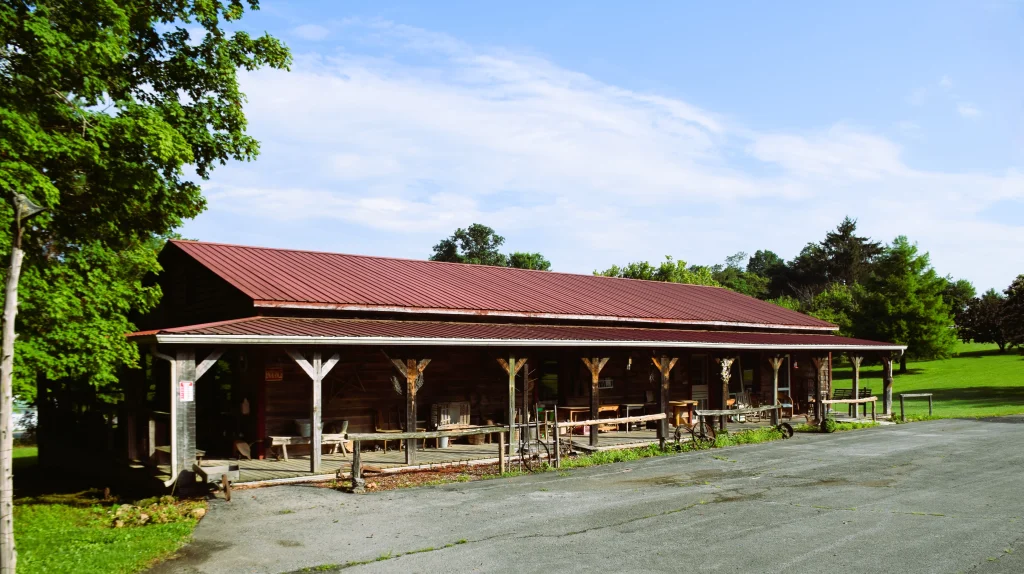 Rustic wood cabin with red metal roofing in White Oak, Kentucky
