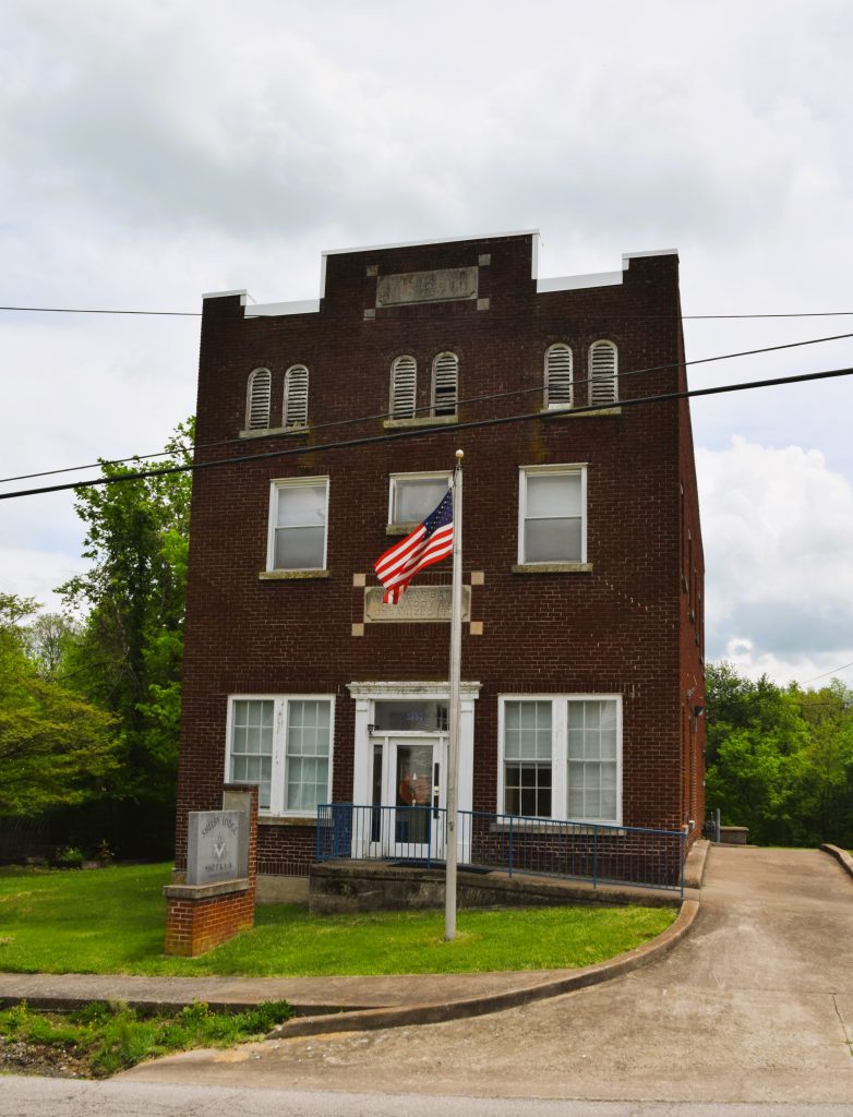 Flat-roof brick building with American flag in Waddy, KY