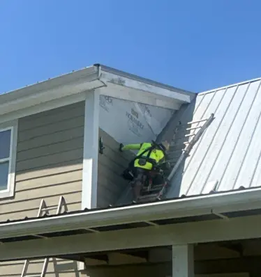 AIC Roofing & Construction crew member installing new siding on a Richmond, KY home