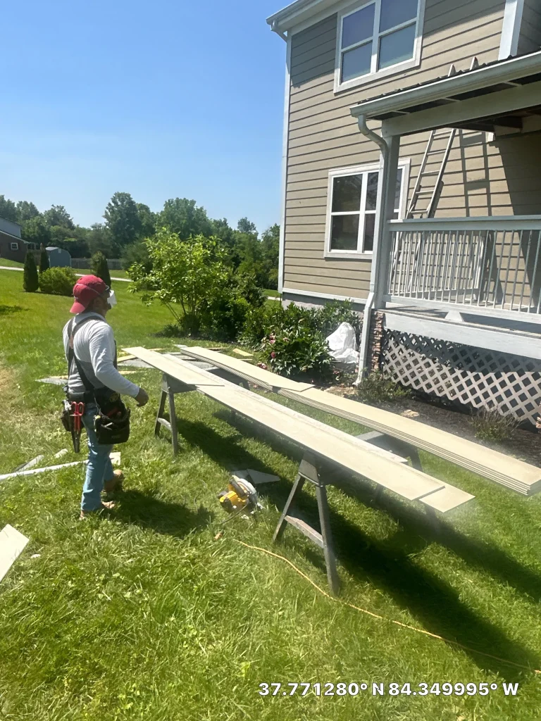 AIC crew member preparing siding boards for installation on a Richmond, KY home