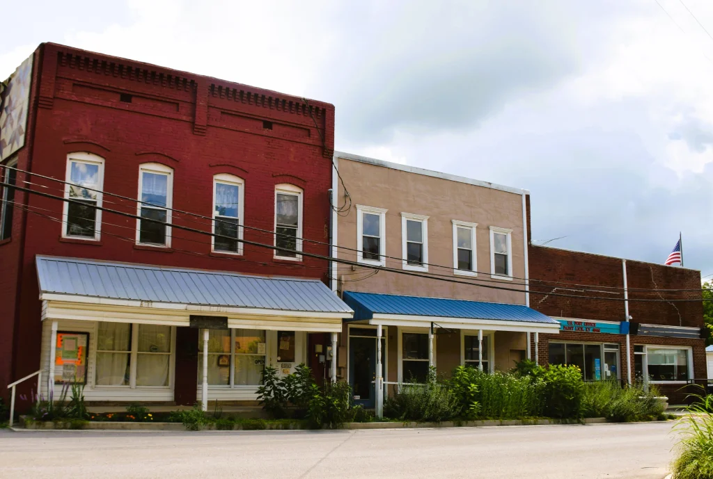 Storefronts in downtown Paint Lick with red, beige, and blue awnings