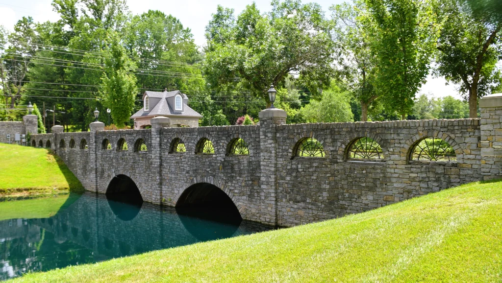 Decorative stone bridge with arched cutouts and lampposts in Prospect, Kentucky