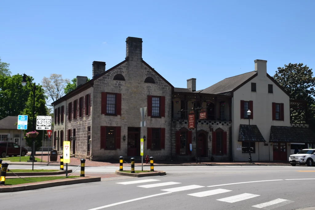 Historic stone Talbott Tavern building with red shutters in downtown Bardstown, KY
