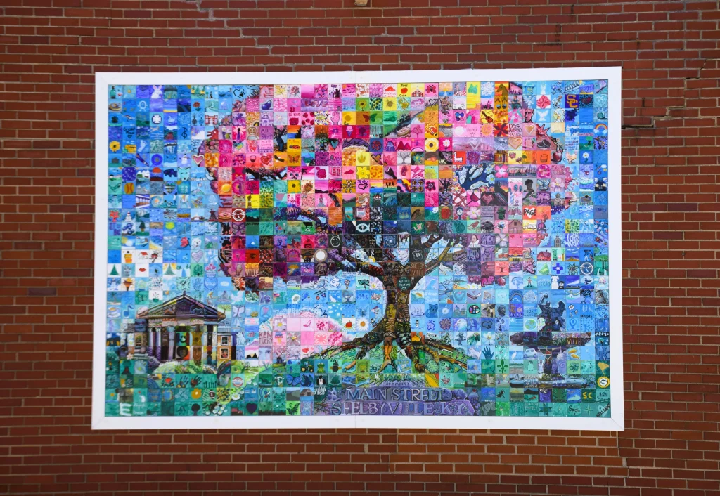 Colorful mural featuring a tree and courthouse on a brick wall in downtown Shelbyville, KY