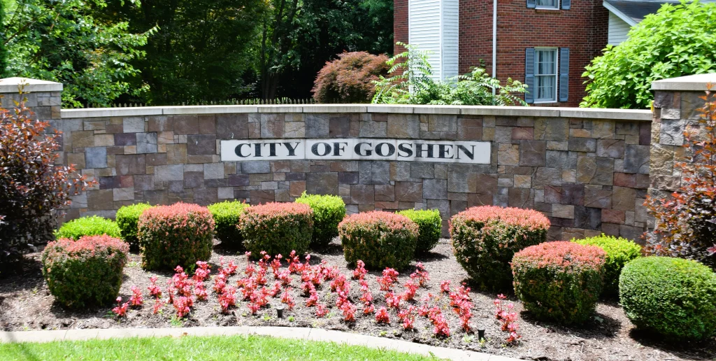 City of Goshen Kentucky entrance sign with stone wall and landscaping
