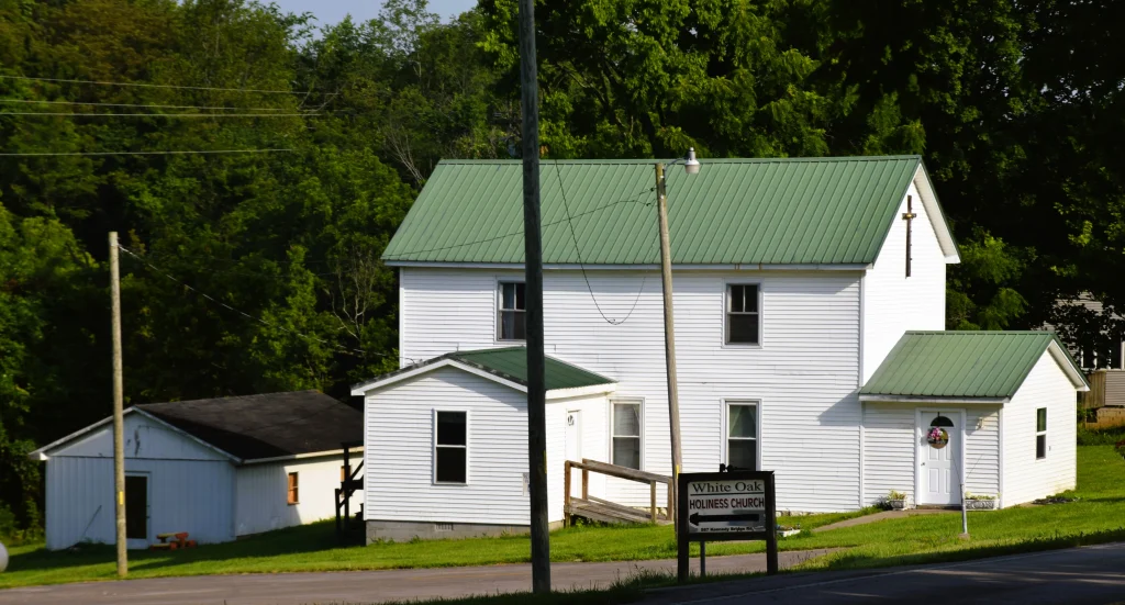 White Oak Holiness Church with green metal roofing and white siding
