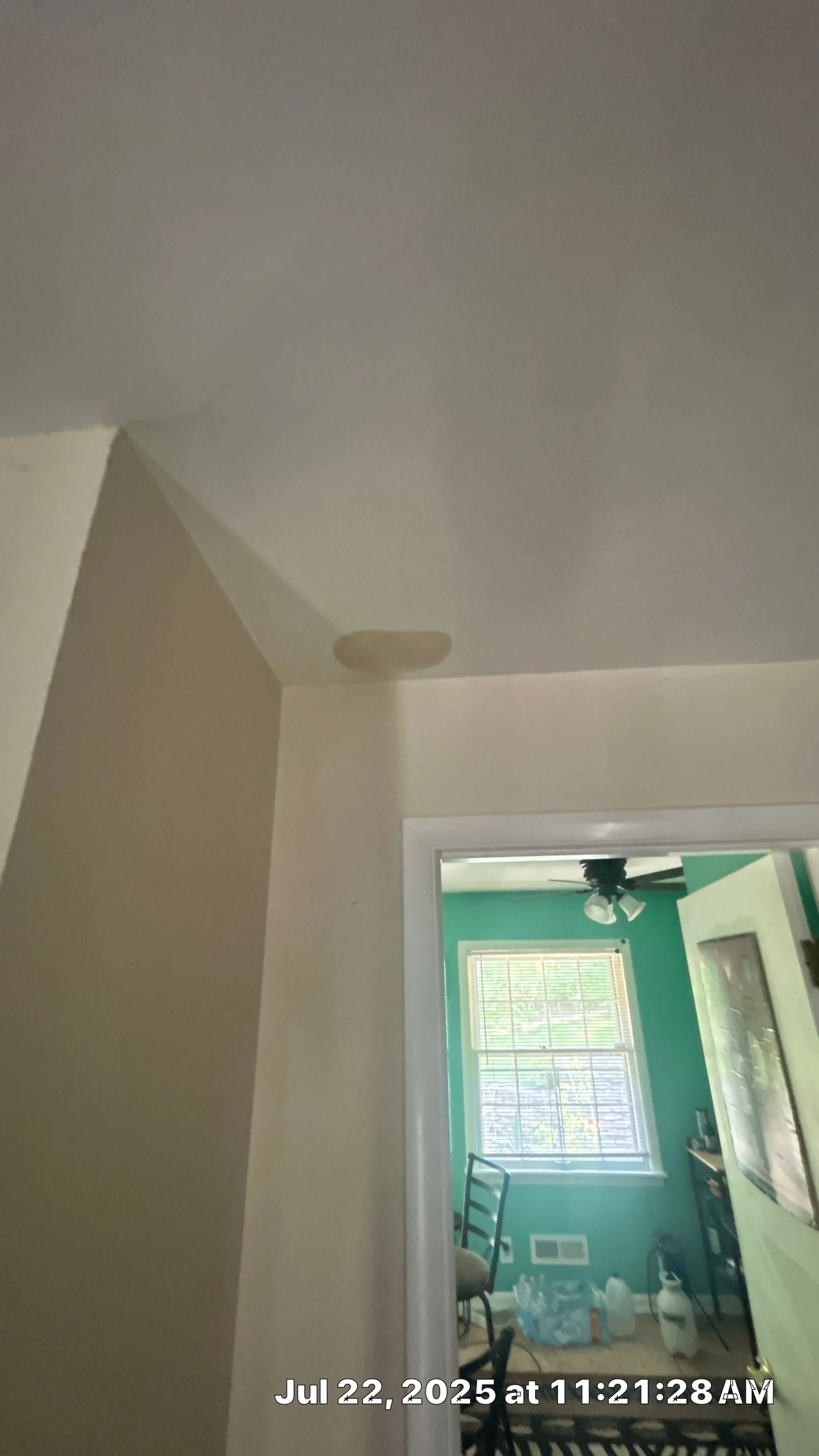 Interior Ceiling Water Stain from Roof Leak – Louisville Interior ceiling corner with a round water stain above a doorway in a Louisville home.