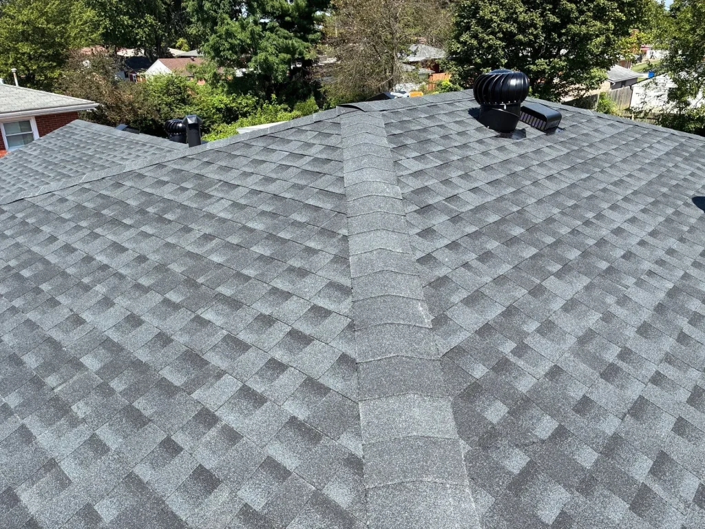 Louisville KY Roof Replacement & Ventilation | AIC Roofing & Construction Overhead view of a freshly shingled roof with ridge cap shingles and attic vents (turbine and static) on a Louisville, KY home by AIC Roofing & Construction.