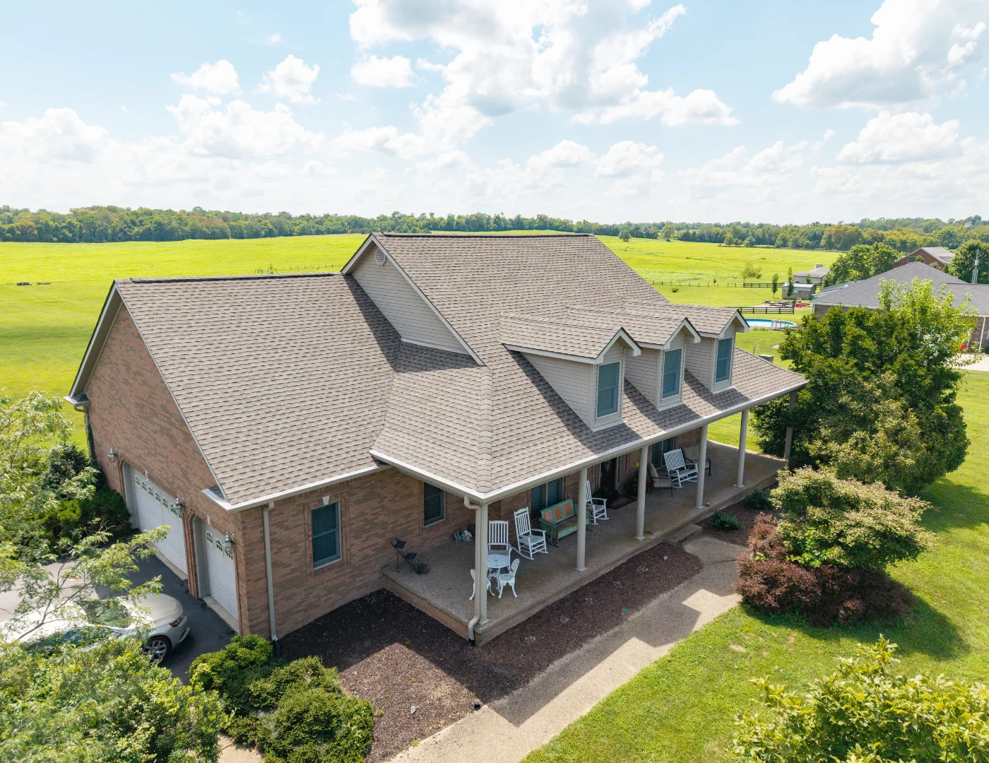 Front view of a home with a complete GAF UHDZ shingle roof replacement by a professional roofing contractor.