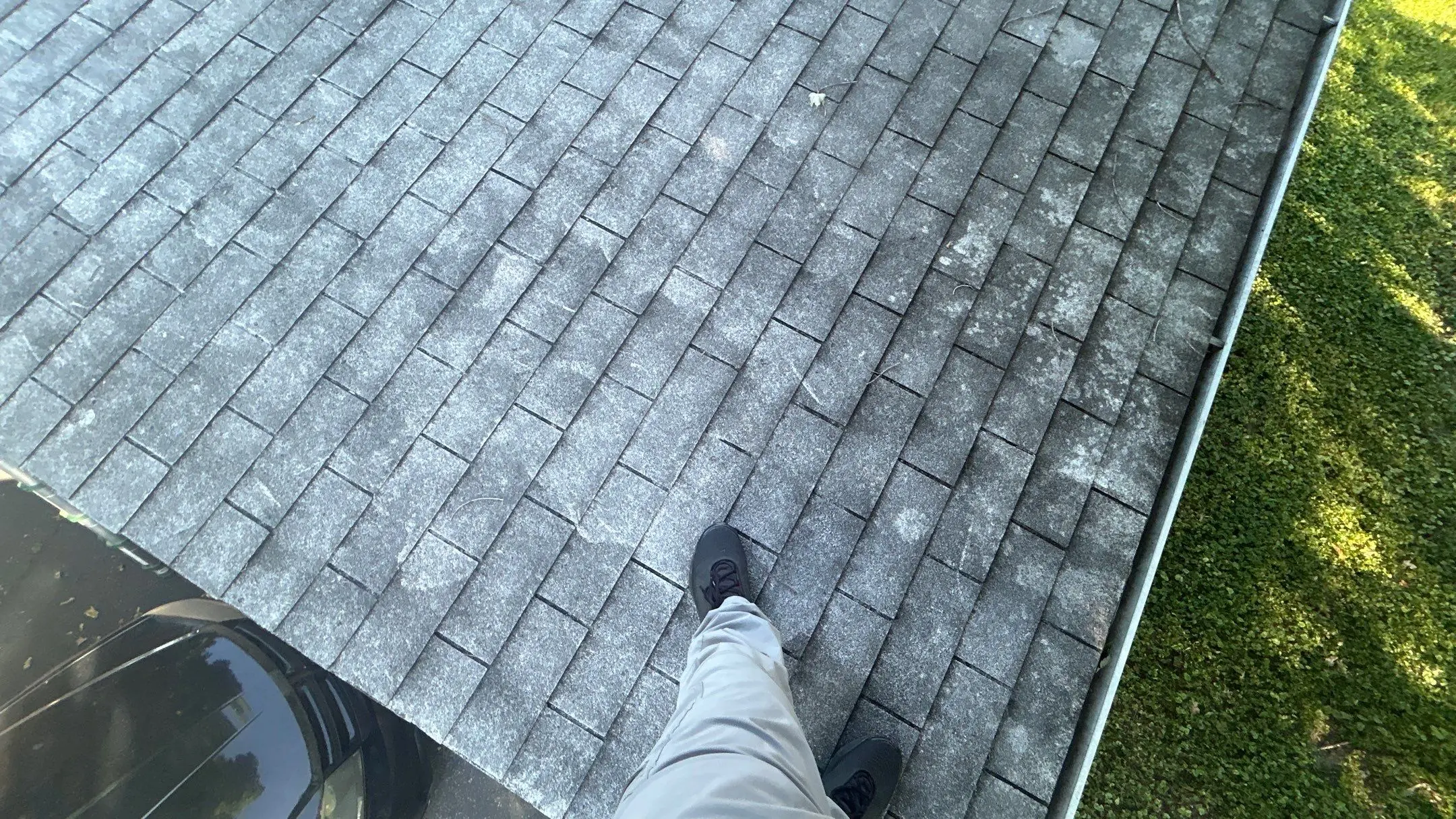 Louisville home with discolored shingles showing signs of roof aging and damage.