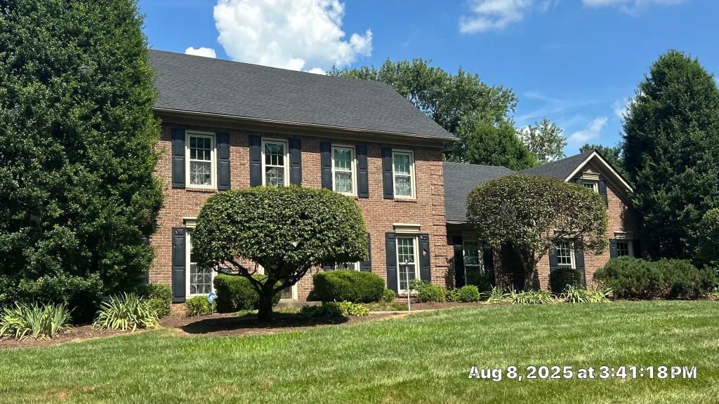 Full roof replacement on a two-story brick home in Goshen, Kentucky, with new architectural shingles and clean roofline.