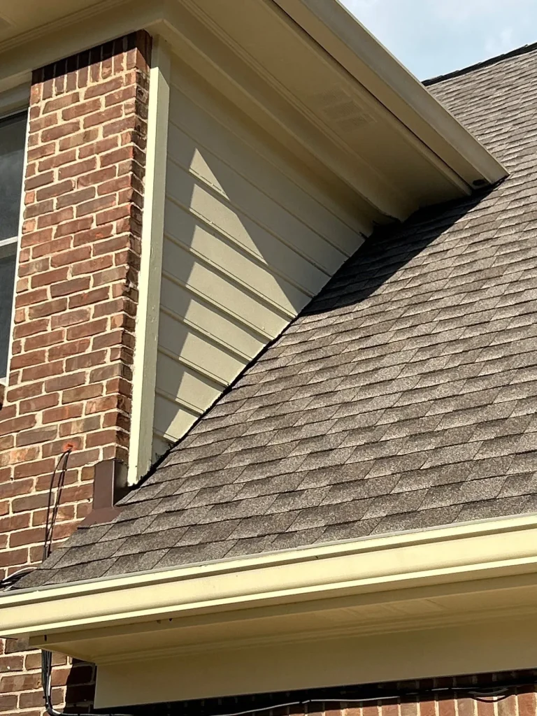 Repaired residential gutter on a Bardstown, KY home with new shingles and improved drainage along the roofline.