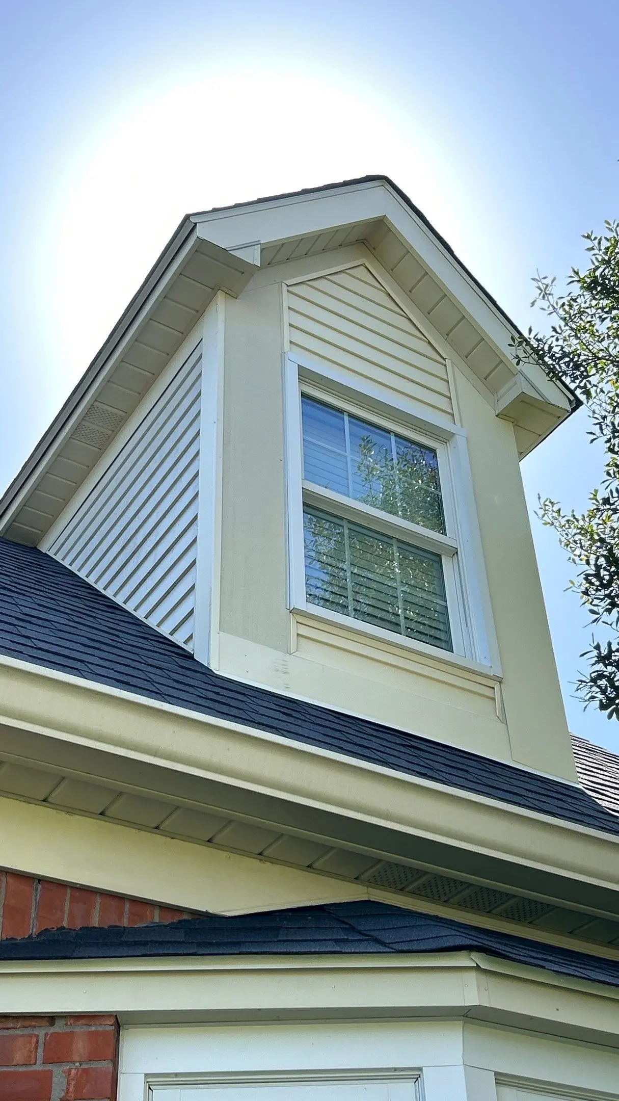 Close-up of a roofline and dormer window with new siding, trim, and shingles on a home in Bardstown, Kentucky.