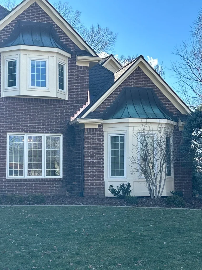 New seamless gutters installed on a luxury brick home in Louisville, Kentucky, enhancing drainage and curb appeal.