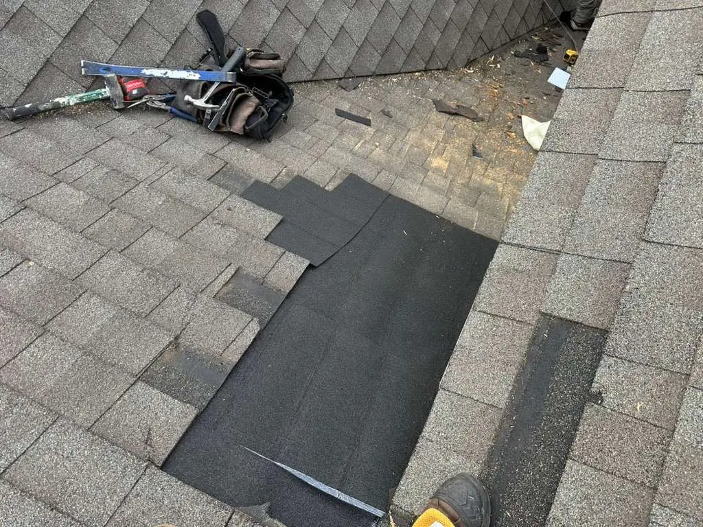 Roof repair in progress on a Louisville, Kentucky home with missing shingles and exposed underlayment.