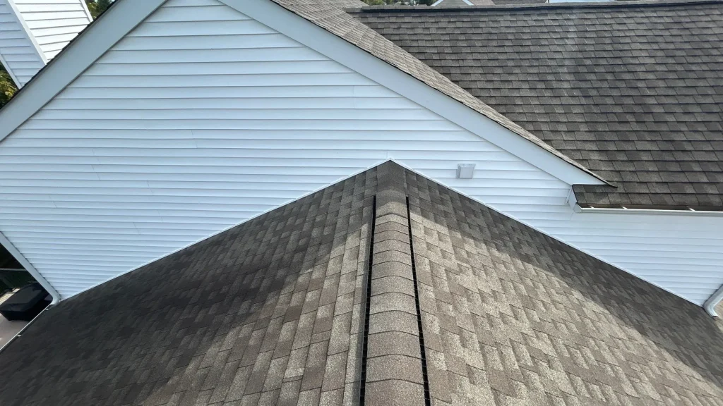 Two-story Louisville home with newly repaired roof featuring brown architectural shingles and ridge vent system.
