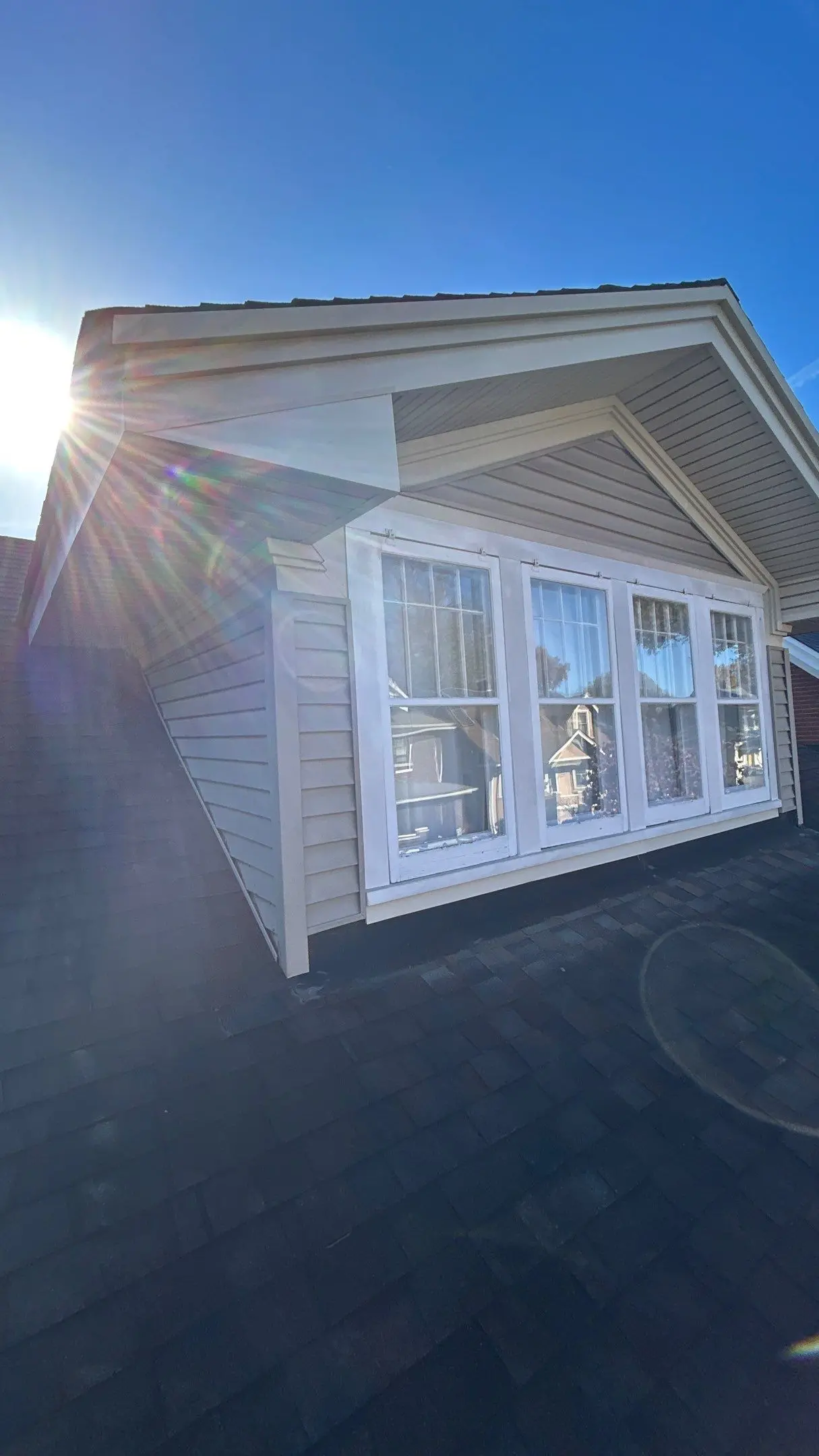 Sunlit dormer on a Louisville, KY home showing siding and trim areas in need of repair.