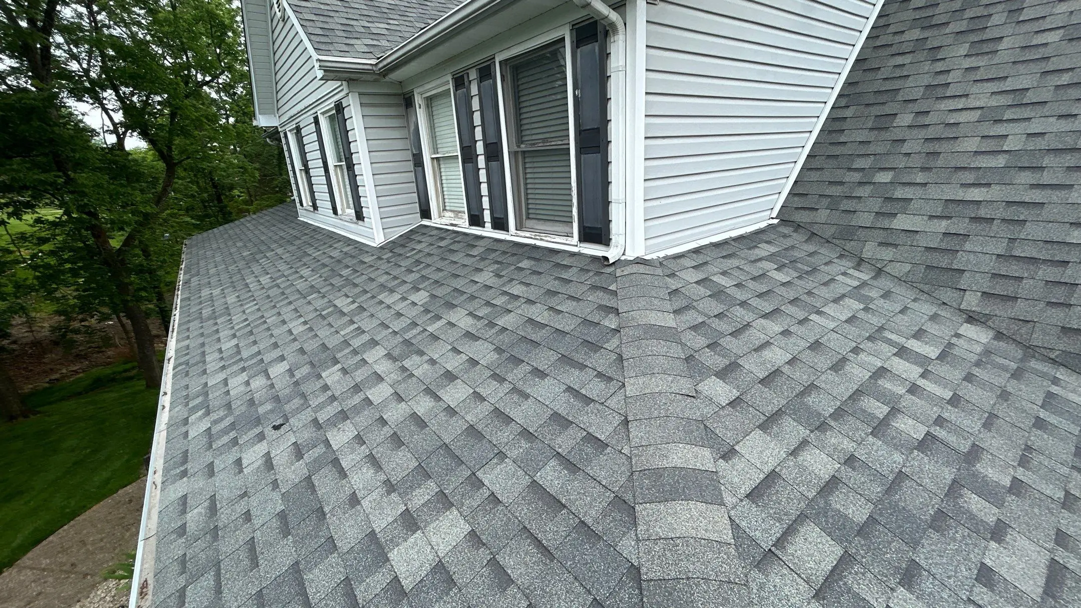 Dormer with worn siding, rotted window trim, and aging shingles on a La Grange, KY home in need of repair.