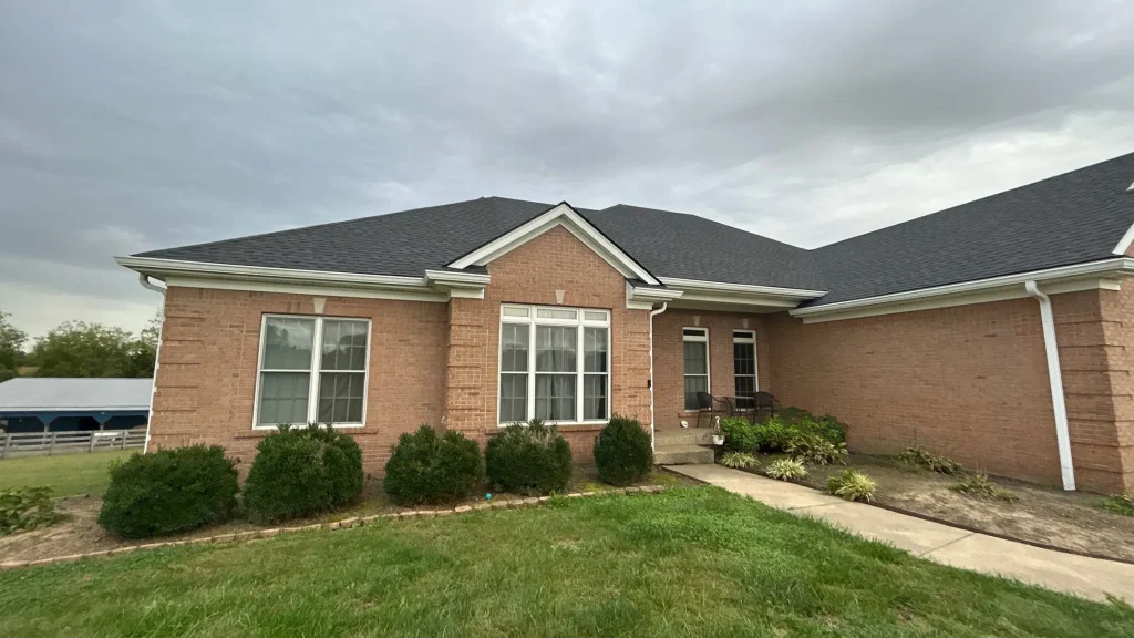 Brick home with a newly installed asphalt shingle roof after a full roof replacement in La Grange KY.