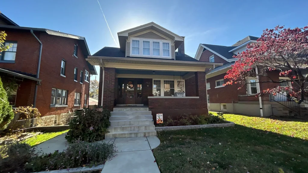 Brick home with a newly installed asphalt shingle roof after a full roof replacement in Louisville KY.