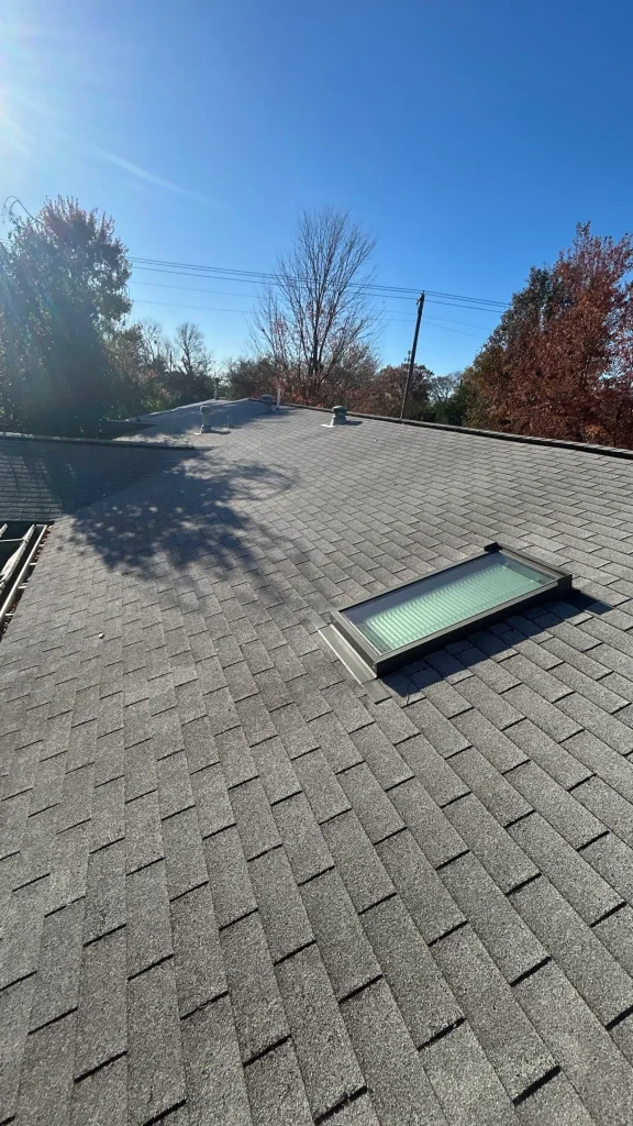 Repaired skylight on an asphalt shingle roof in Louisville, KY under clear blue skies.