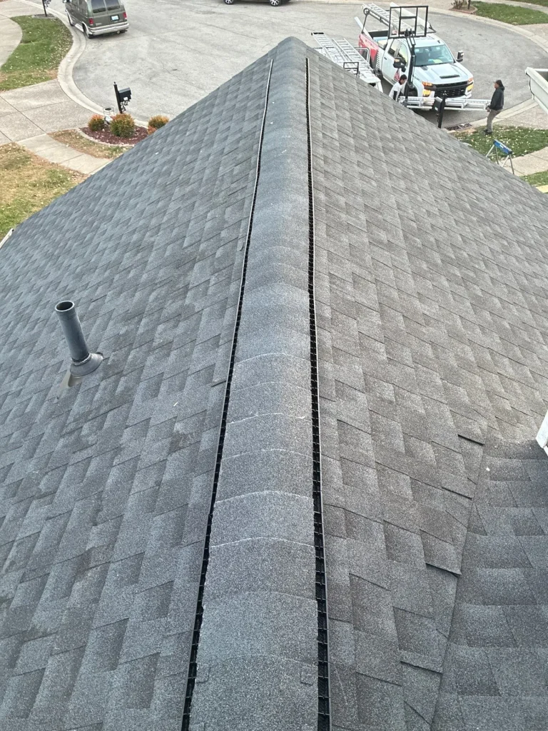 New roof repair with clean shingles and ridge vent on a Louisville, KY home overlooking a cul-de-sac