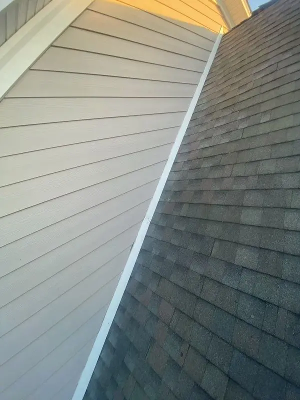 Step flashing along the siding and shingle roof of a La Grange, KY home during a roof inspection.