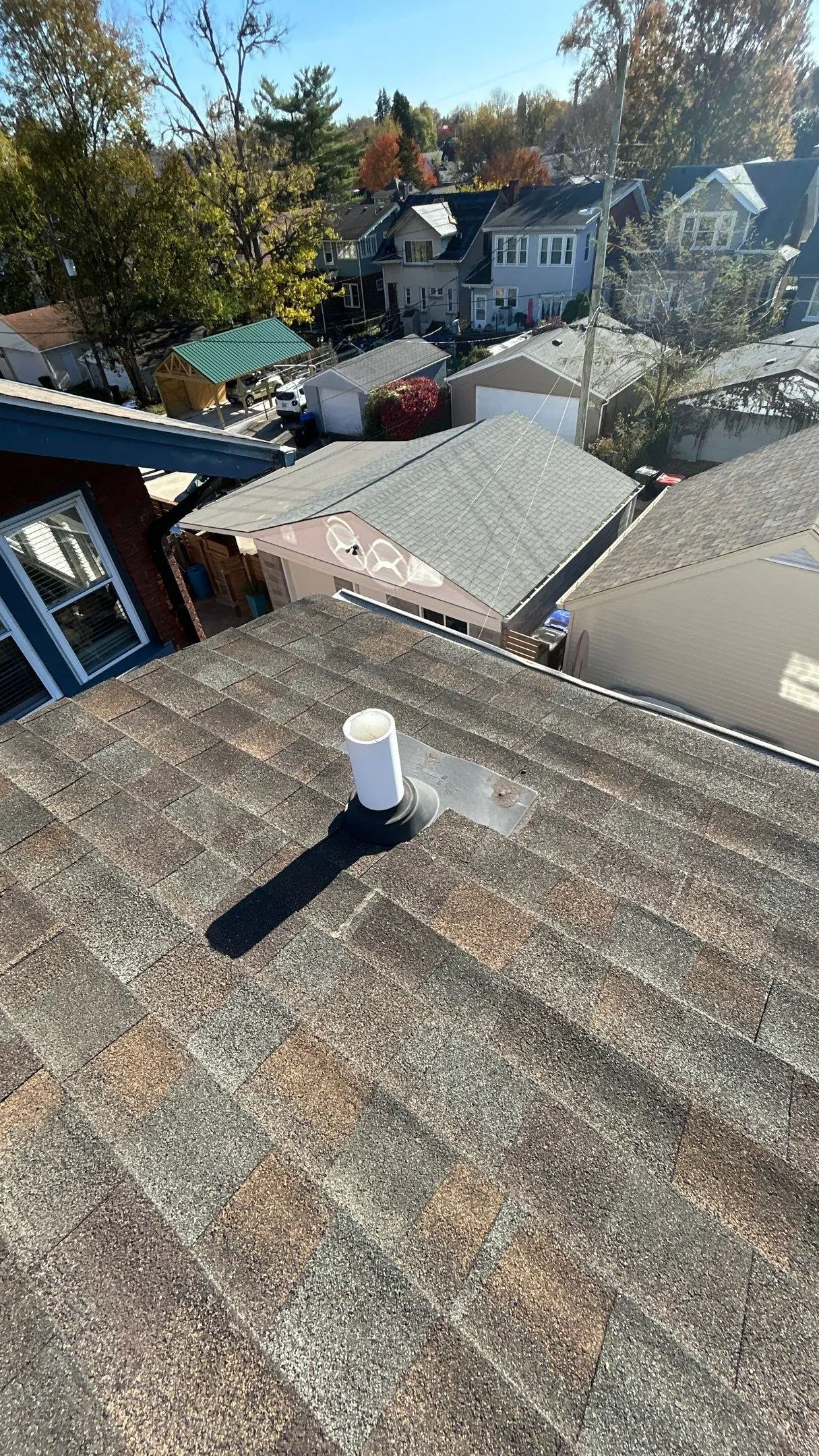 Roof penetration with worn vent boot and aging flashing on a Louisville, KY roof needing repair.