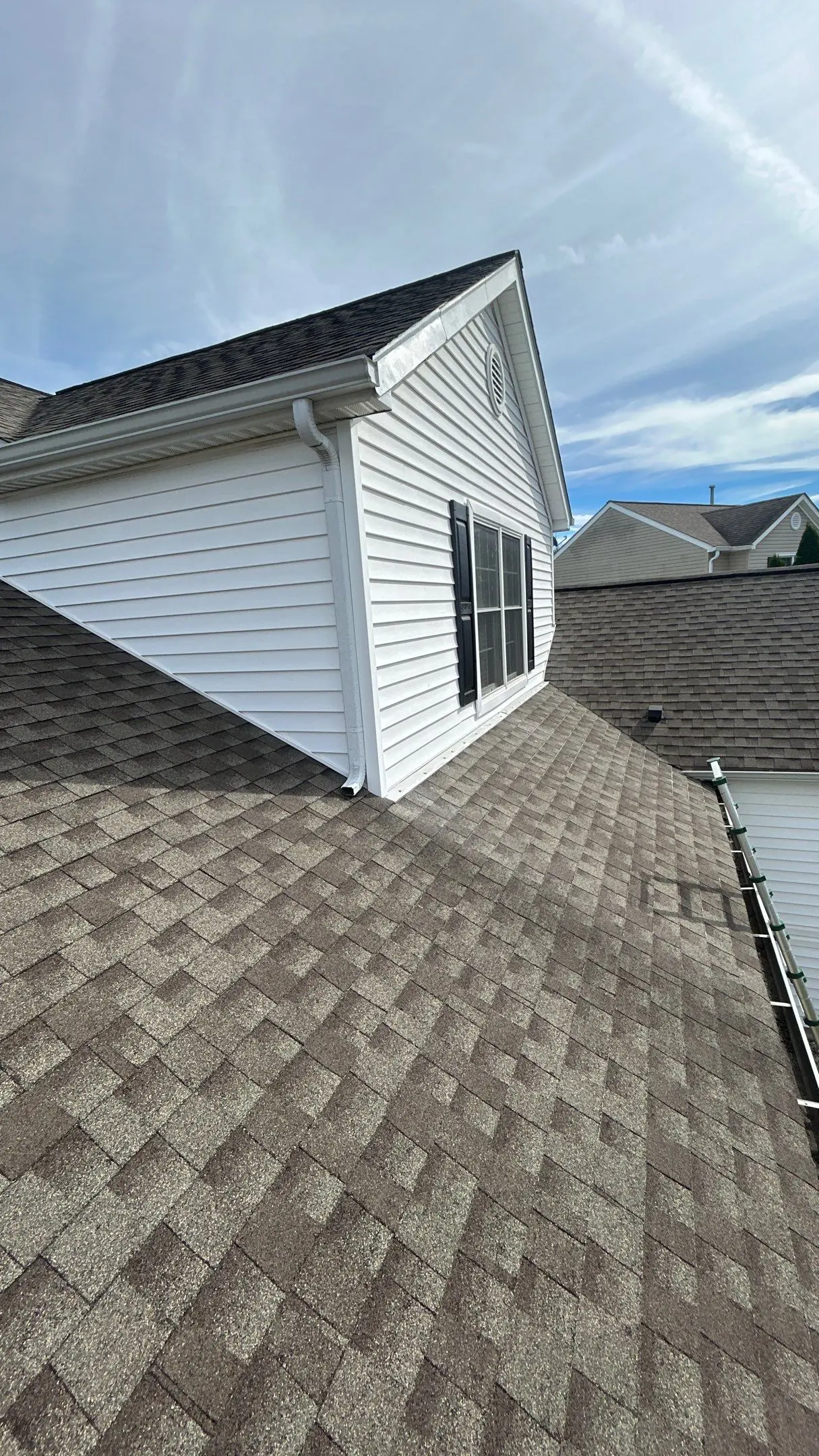 Roof with faded, weathered shingles on a Louisville, KY home needing repair