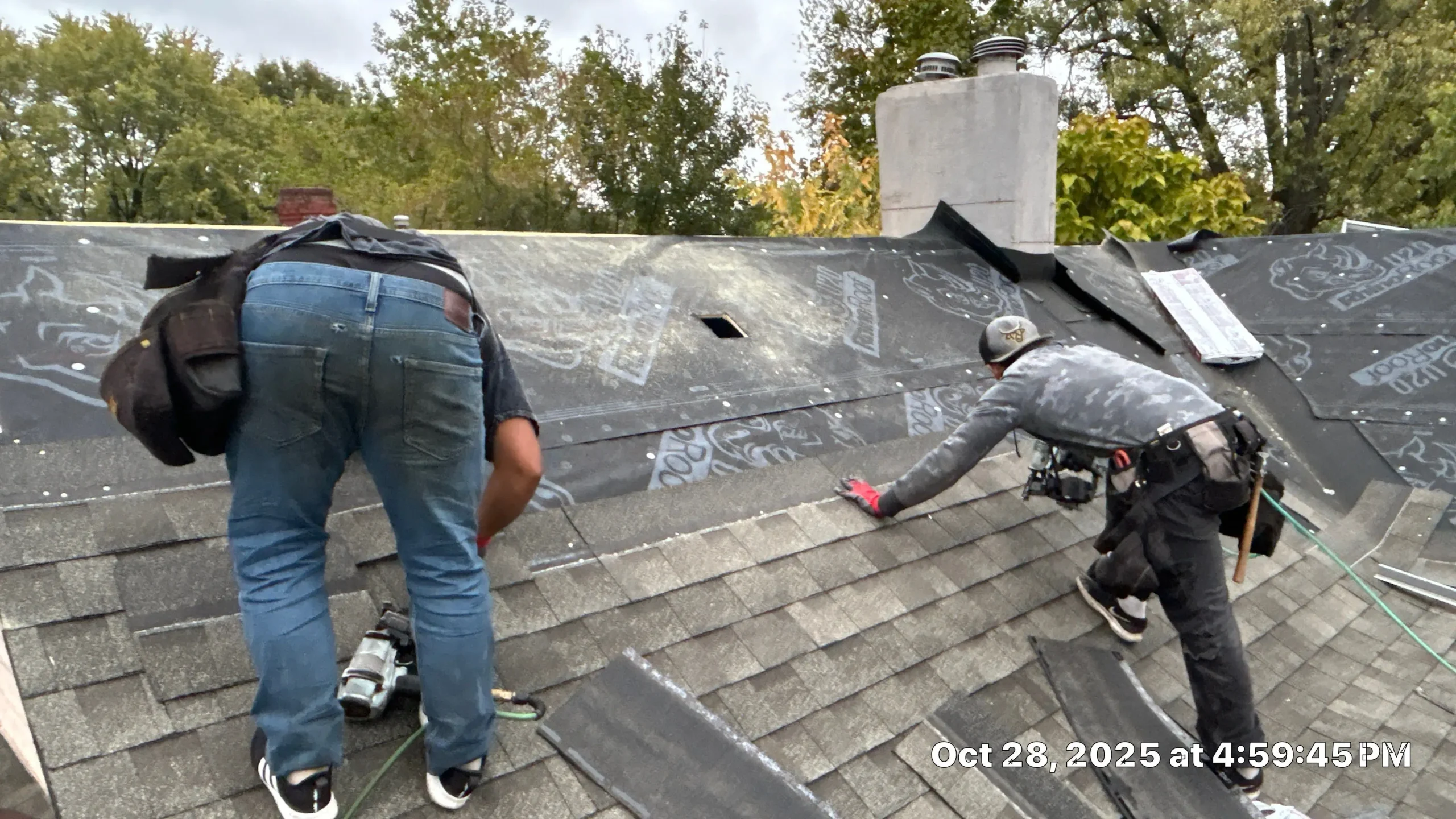 Aging Roof with Discolored Shingles on Louisville Building Roofing crew installing new shingles and underlayment on a Louisville KY home, with tools and materials visible on the roof.