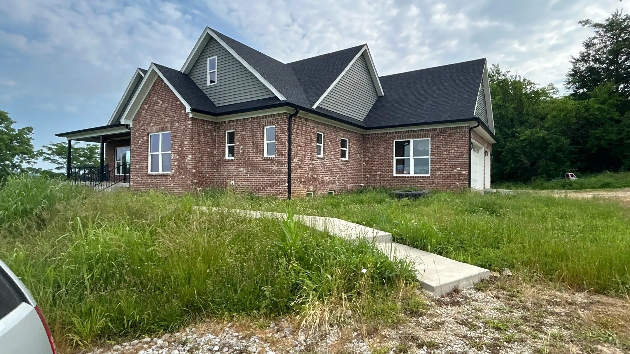 Roof replacement completed on a brick home in Taylorsville, Kentucky with new asphalt shingles
