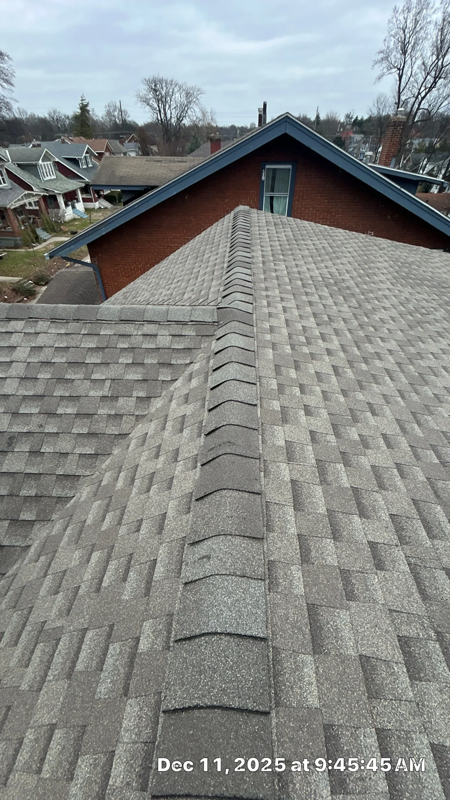 Properly installed ridge cap shingles forming a sealed roof ridge on an asphalt shingle roof
