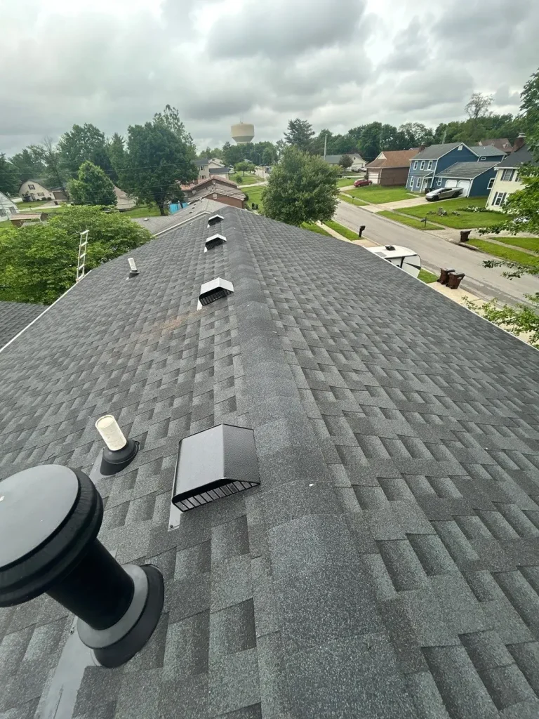 Finished asphalt shingle roof with straight ridge line and properly installed roof vents