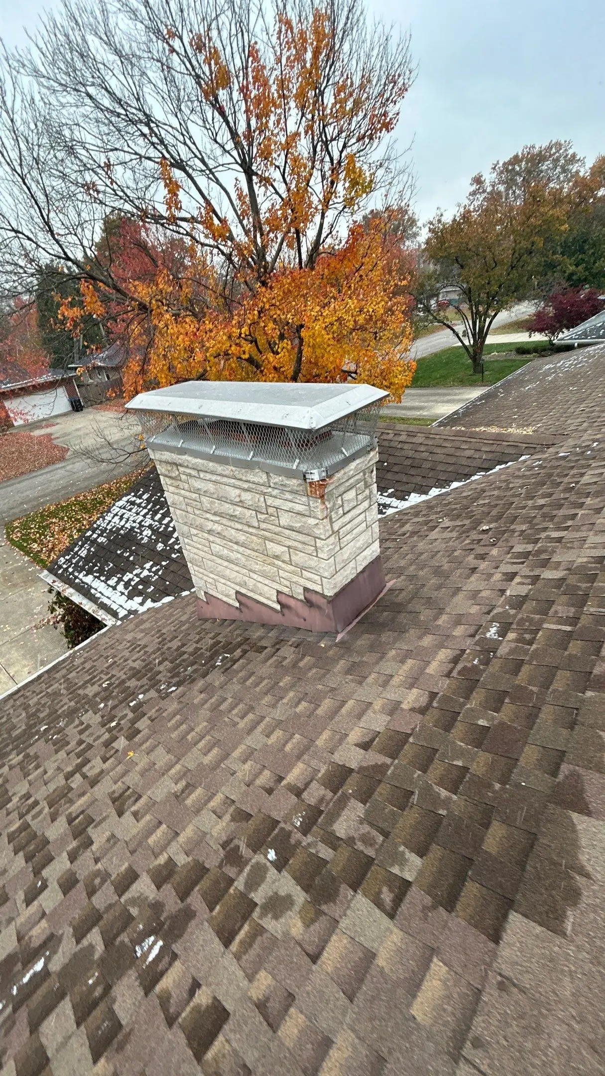 Chimney cap and flashing installed on asphalt shingle roof in Louisville, KY
