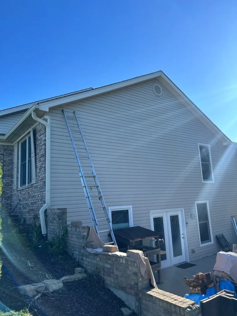 New vinyl siding installation on a Louisville KY home showing full side elevation and clean horizontal siding