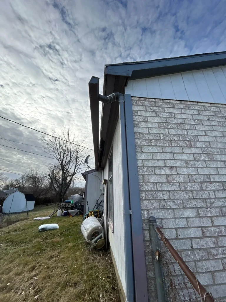 Failing gutter and downspout system on a home in Nicholasville, KY