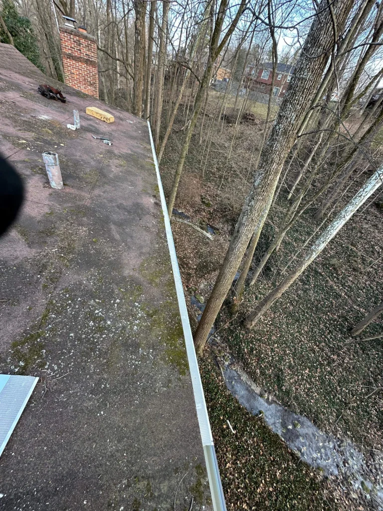 Gutter guards installed along the roof edge of a home in Louisville, KY