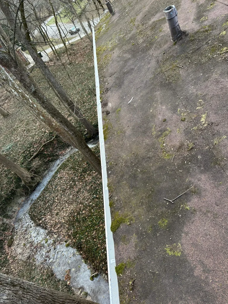 Gutter guards installed on a wooded Louisville, KY home overlooking a creek