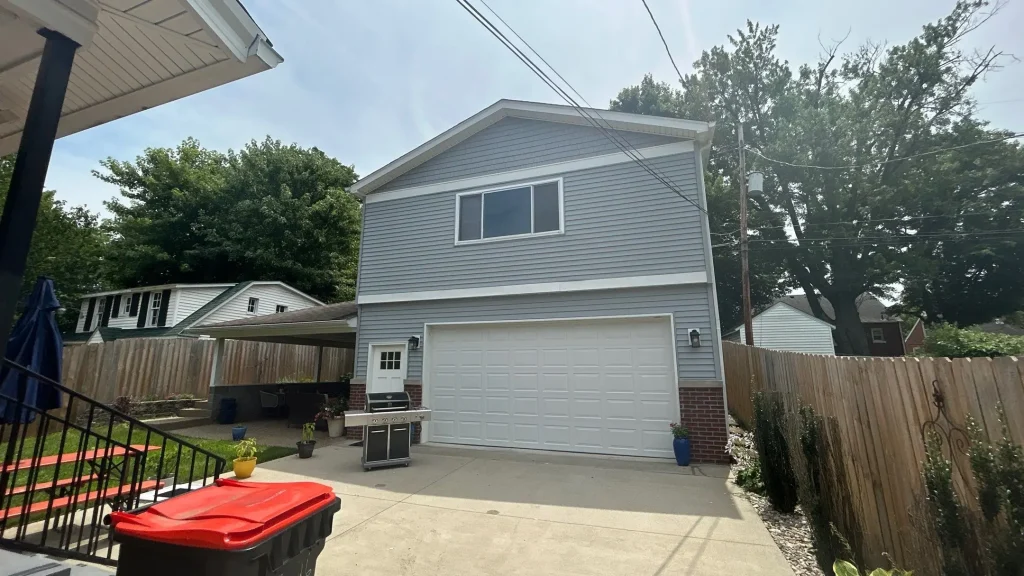 Newly installed siding on a Louisville, KY home with detached garage