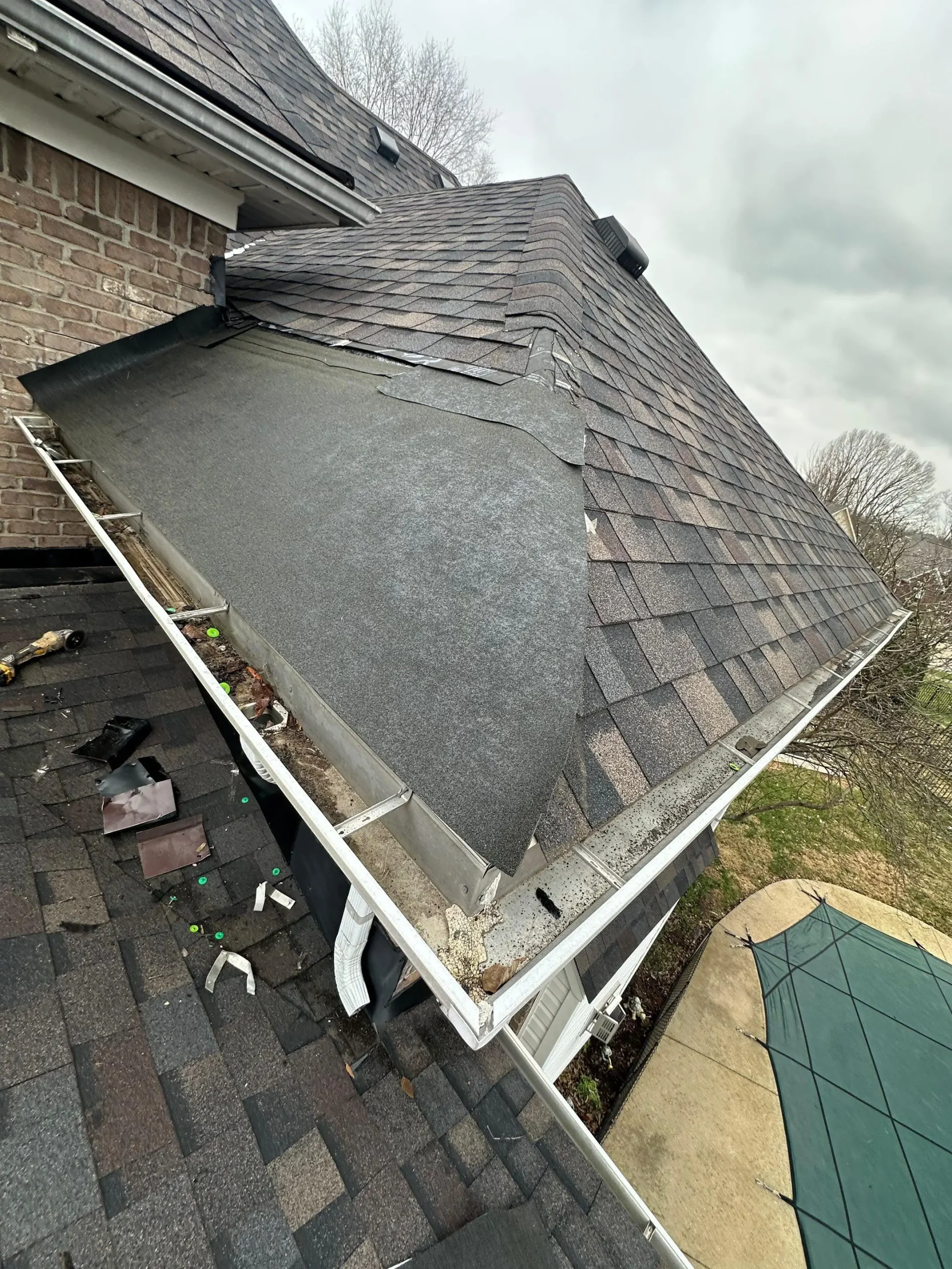Roof repair in Louisville KY showing exposed ice and water shield and roof valley preparation