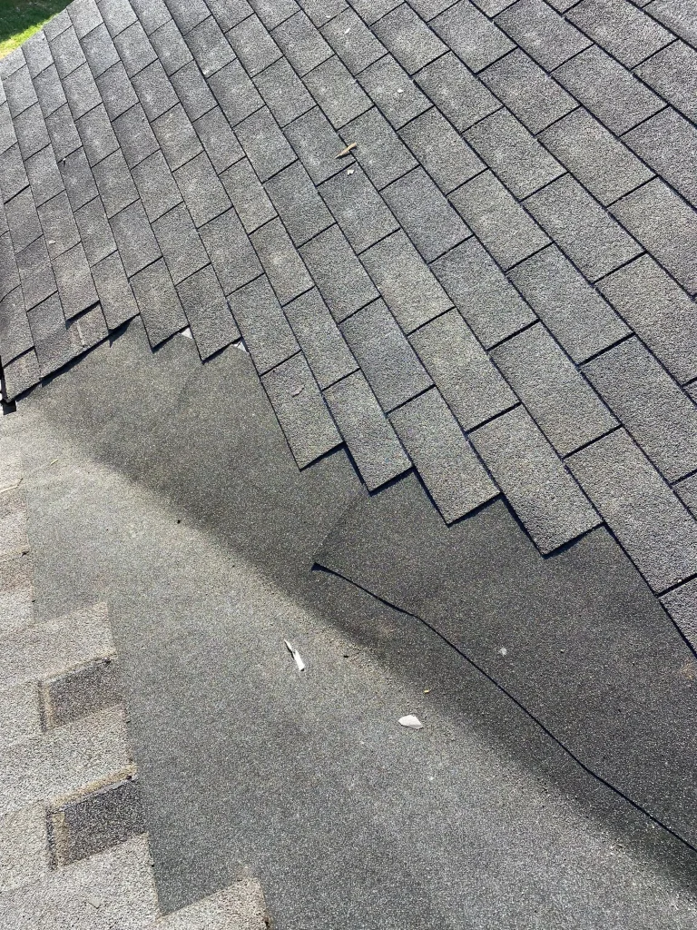 Missing asphalt shingles on a roof in Pewee Valley KY exposing underlayment