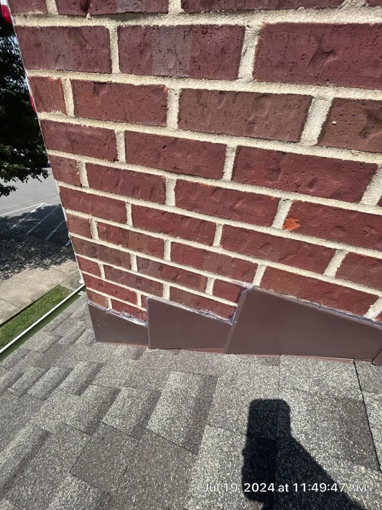 New chimney flashing installed on an asphalt shingle roof in Louisville, KY