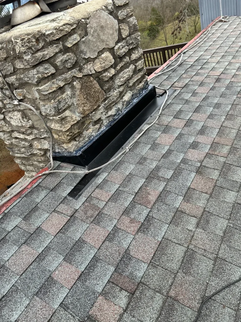 New metal chimney flashing installed on an asphalt shingle roof in Nicholasville, Kentucky