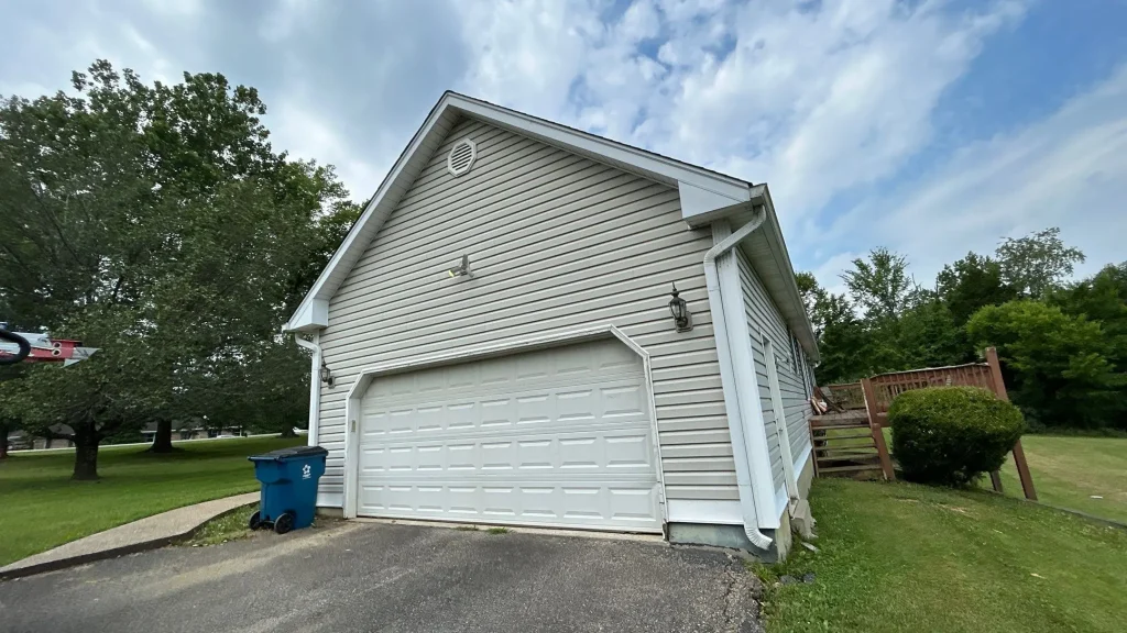 New vinyl siding installed on a Crestwood KY home with attached garage and clean exterior finish