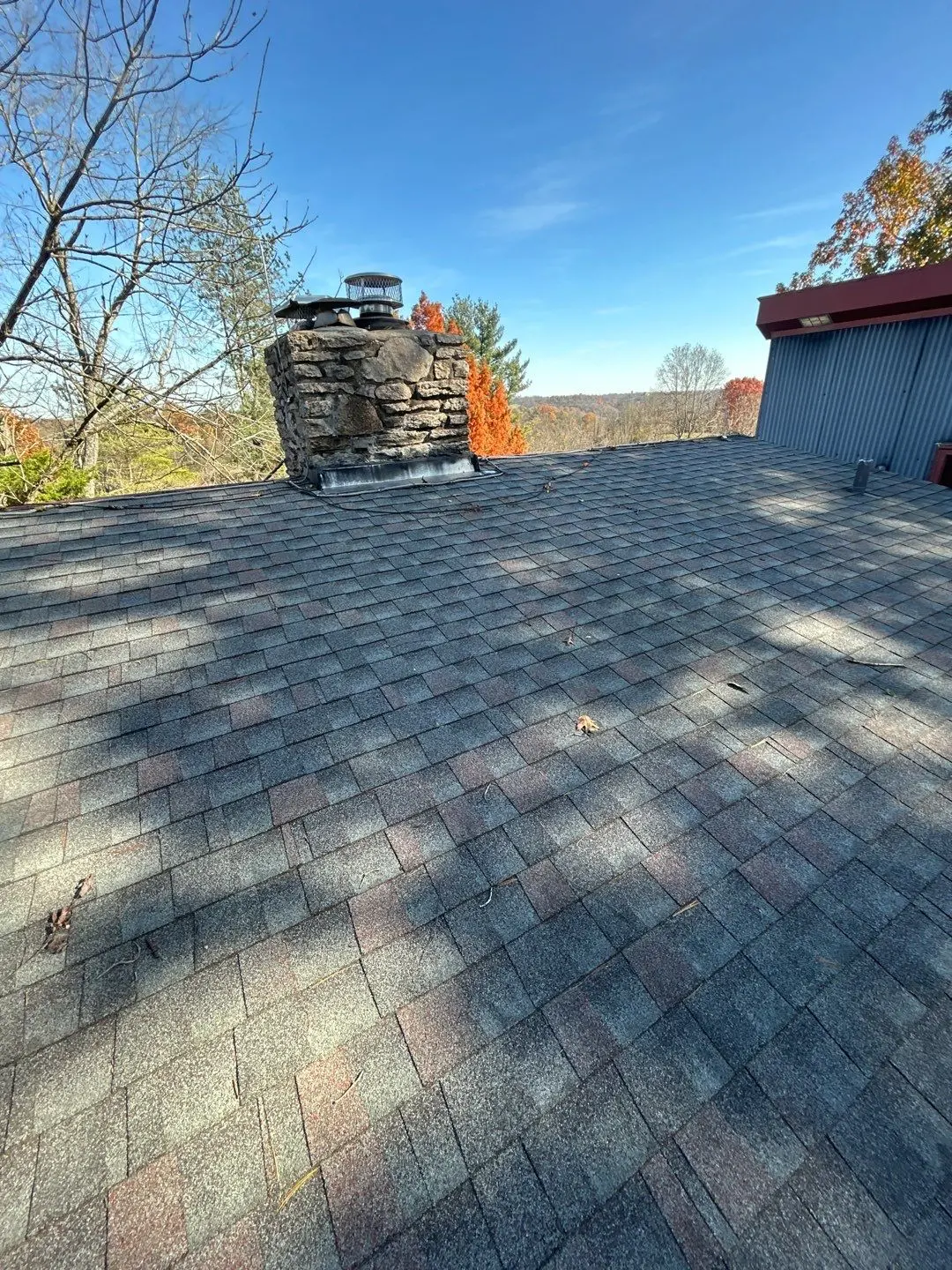 Asphalt shingle roof with chimney on a Nicholasville KY home during roof inspection